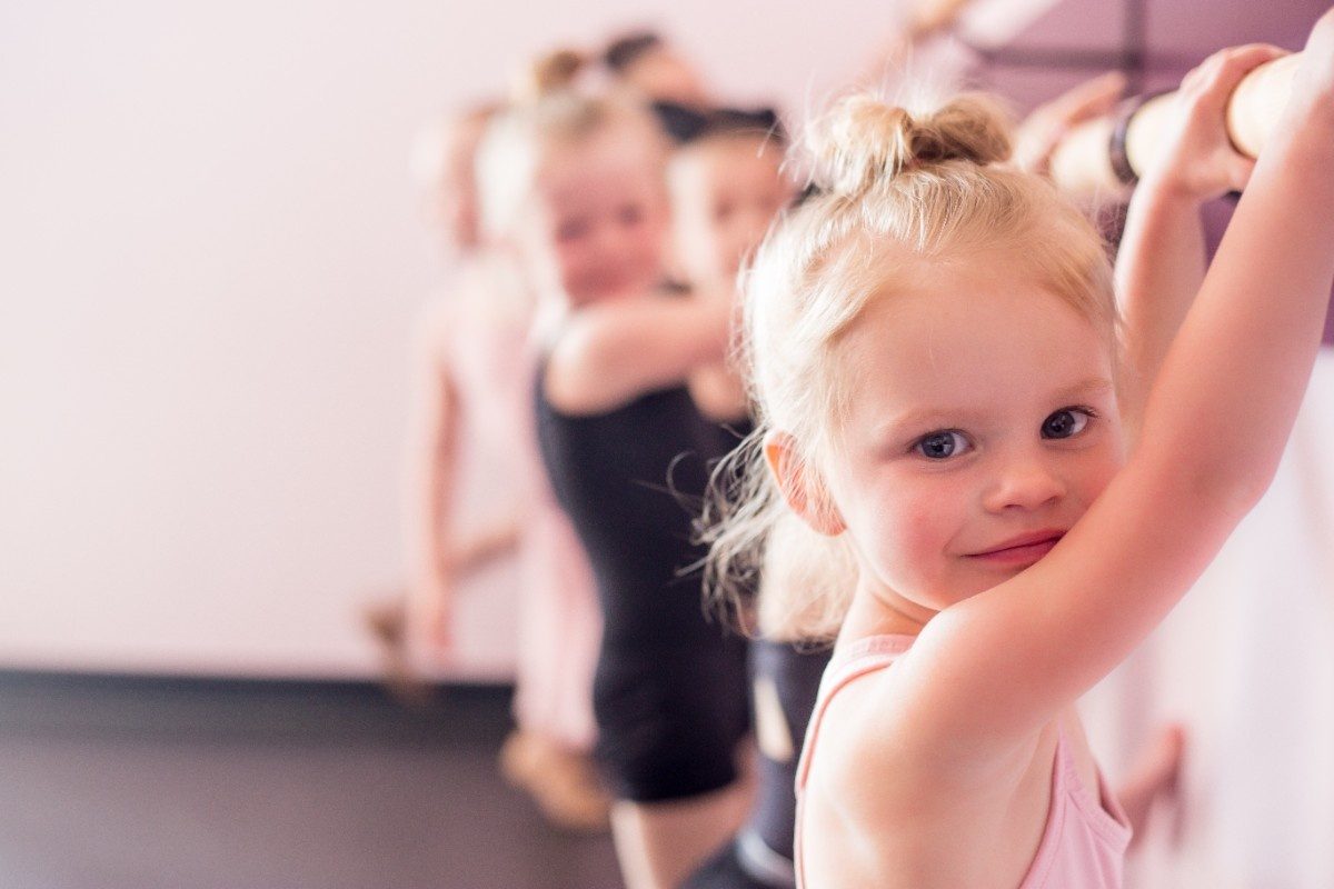 Tiny dancers at a ballet barre