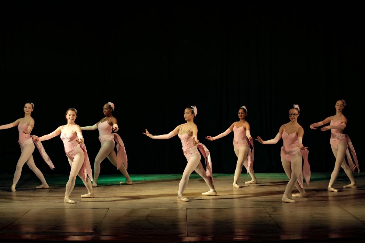little girls in ballet attire performing on stage