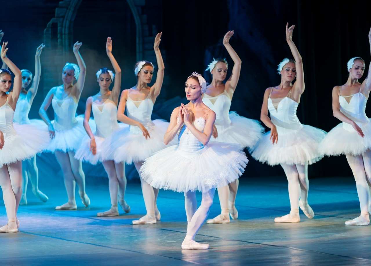 A ballerina in the middle of other ballerinas performing