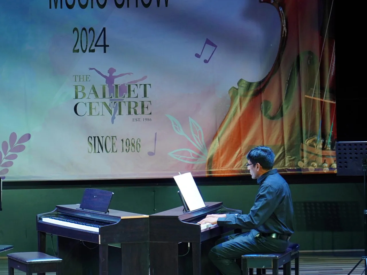 A student accompanying on piano at the annual music show