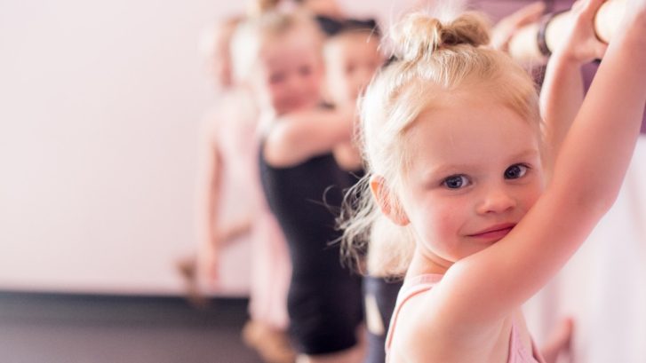 Tiny dancers at a ballet barre