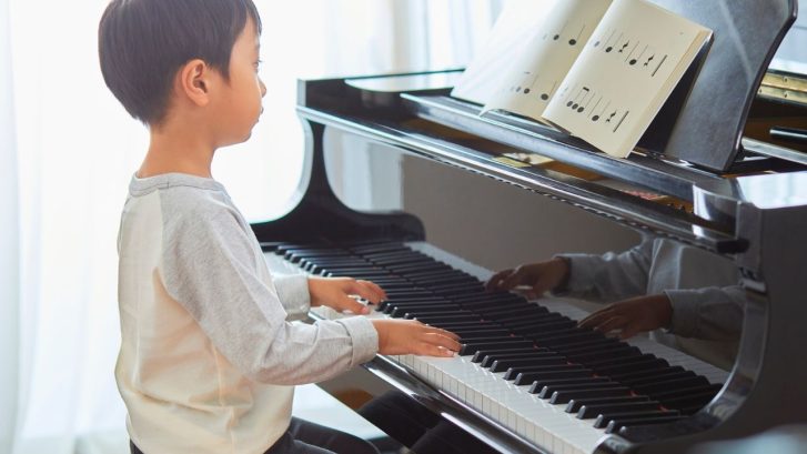 A little boy playing the piano