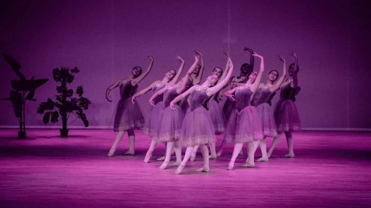 Group of girls performing ballet dance on stage