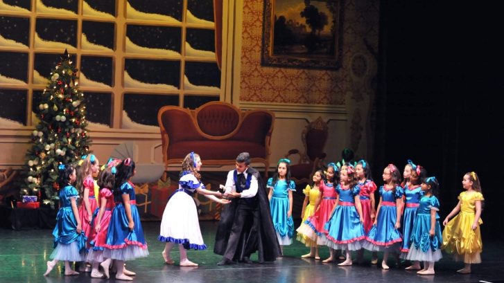 Children on stage acting wearing various costumes